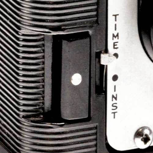 Black button, white dot, switch to right labeled 'Time' above and 'Inst' below