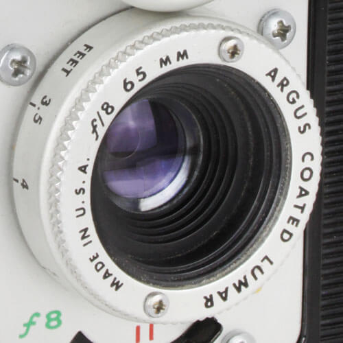 lower lens labeled 'f/8 65mm ARGUS COATED LUMAR', switch marked 'f8 11 16' below lens